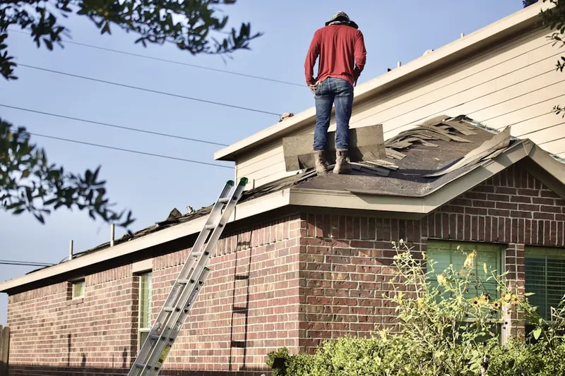Professional roofer working on a residential roof in Gretna
